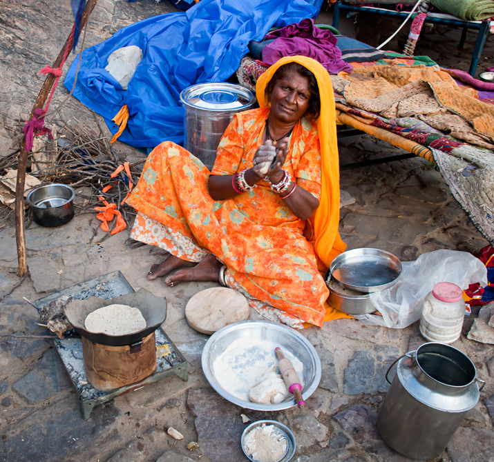 Jaipur, india-sept 26 : indian woman preparing a meal on the street, on the way to surya mandir or temple of the sun god, september 26, 2013 in jaipur, rajasthan, india. Photo Credit: Olena Tur